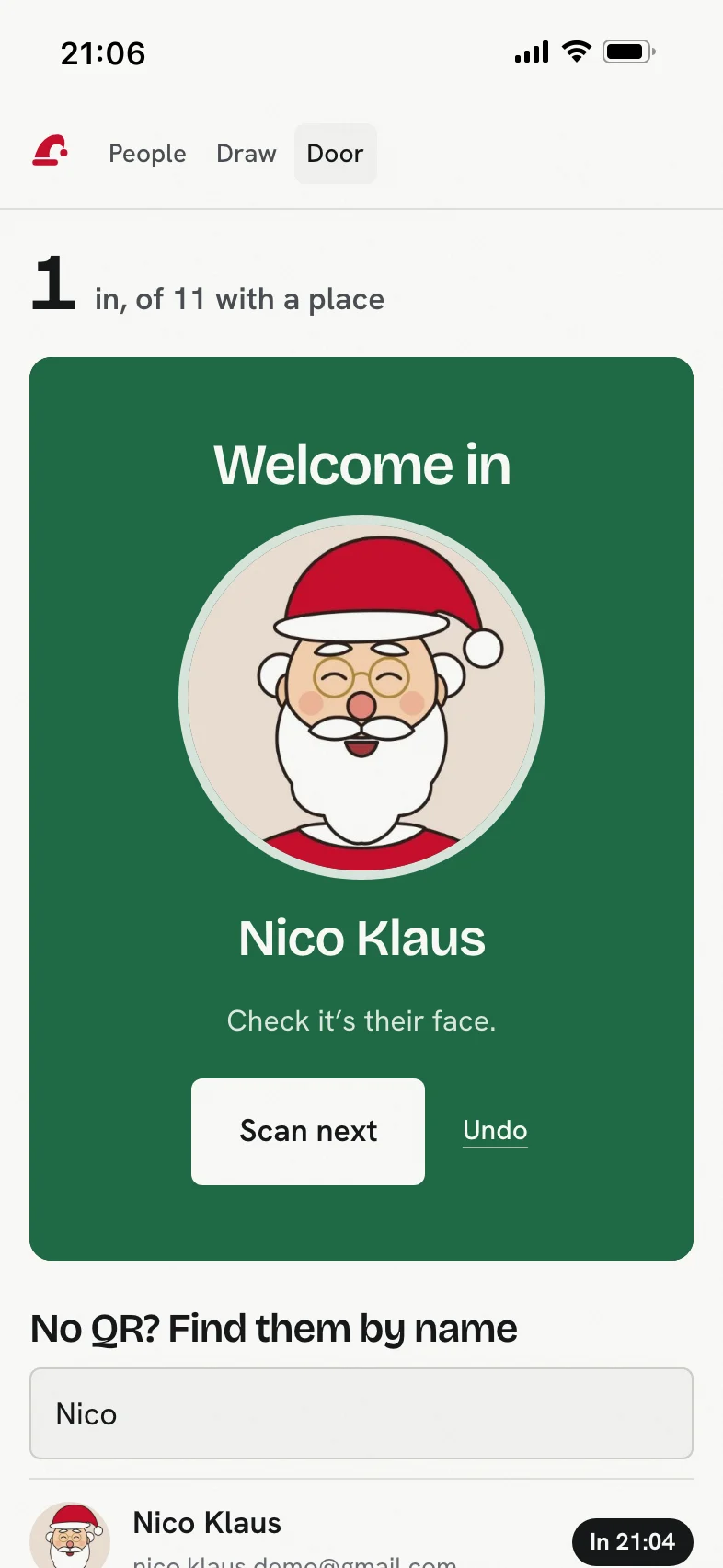 The door scanner on an organiser's phone: a green card saying Welcome in, with a drawing of Santa as the made-up guest, Nico Klaus, and Check it's their face.